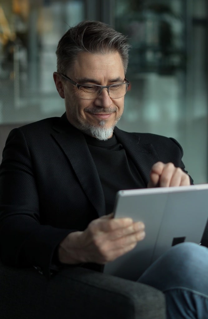 Businessman working online with tablet, representing Financial Planning